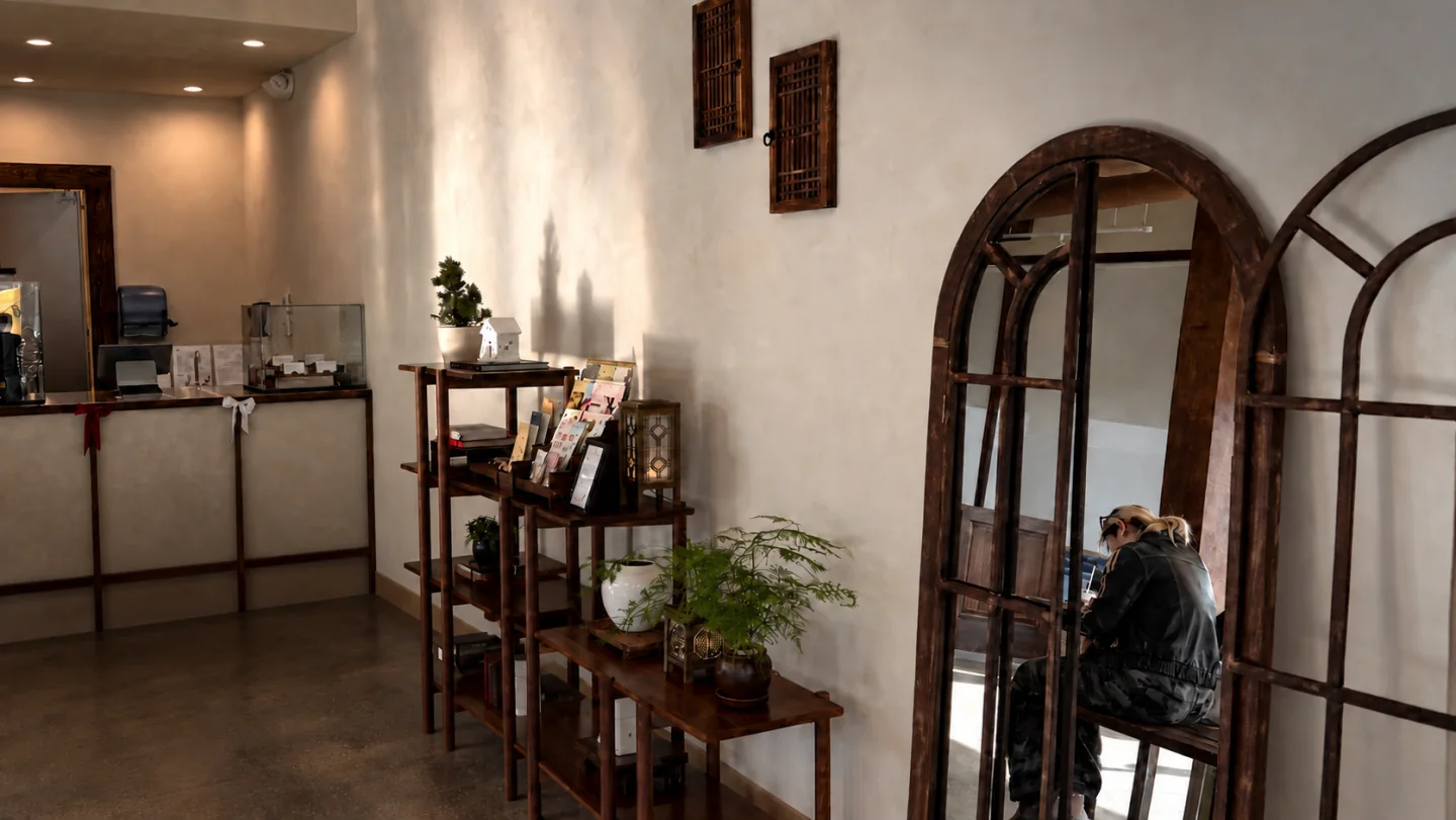 Warm plaster walls, old wooden mirrors and shelves inside Way Home Coffee.