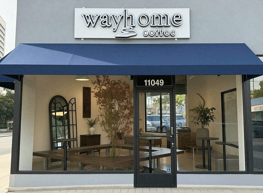 Way Home Coffee storefront on Santa Monica Blvd: navy awning, glass front, the benches and tree visible inside.