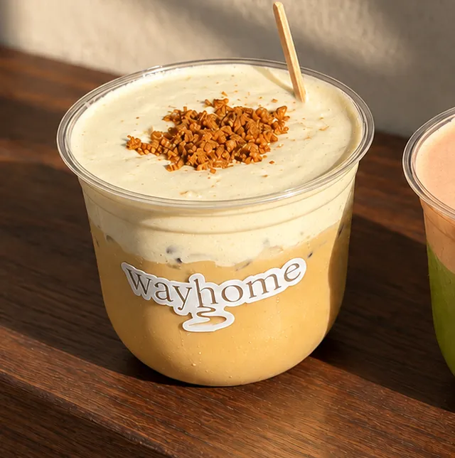 Close-up of the banana cream injeolmi latte with toasted soybean crumble.